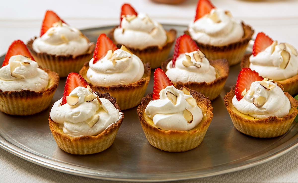almond flour custard tarts with whipped cream and strawberry on top